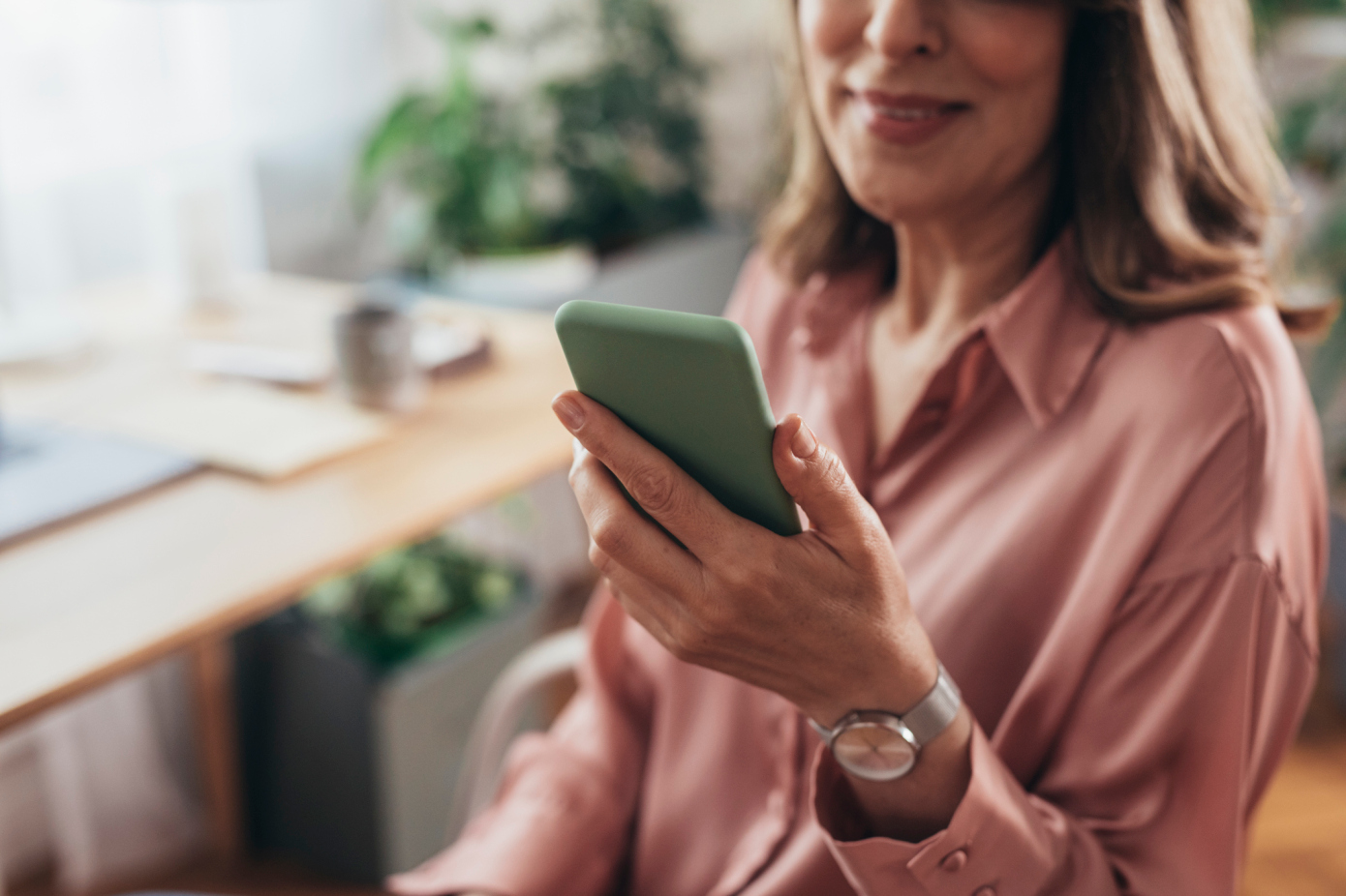 Working from Home to Flatten the Curve: a Beautiful Happy Senior Woman Using her Smartphone at her Home Office GetCallers | My Interview raises $5 million for its video-based job recruitment platform