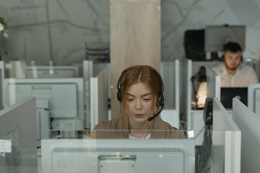 Virtual Assistants being utilized in a bustling telemarketing call center environment.