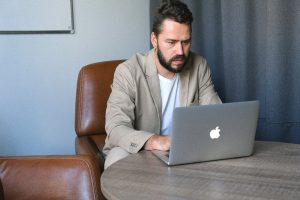 Virtual assistant working on a laptop in an office setting.