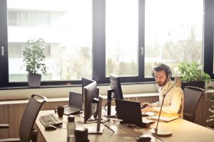 A Virtual Office Assistant service provider using laptop in his office